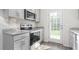Modern kitchen features stainless steel appliances, granite countertops, and an access door to the outside at 236 Moyer Dr, Graham, NC 27253
