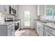 Modern kitchen featuring stainless steel appliances, white cabinets, and granite countertops at 236 Moyer Dr, Graham, NC 27253