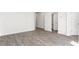 Clean living area boasting hardwood floors, white walls, and a view of a nearby bathroom at 236 Moyer Dr, Graham, NC 27253