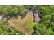 An aerial view of a home with a large yard, a long driveway, and surrounded by trees at 237 Jason Way, Youngsville, NC 27596