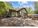Rear exterior of home with gravel parking, patio, and two car garage at 237 Jason Way, Youngsville, NC 27596
