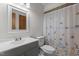 Neutral bathroom with a shower/tub combo, butterfly shower curtain, gray vanity, and a coordinating framed mirror at 237 Jason Way, Youngsville, NC 27596