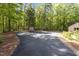Wide driveway with parking for multiple cars, storage shed, and wooded views surrounding the property at 237 Jason Way, Youngsville, NC 27596