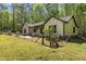Well-maintained home exterior, featuring mature landscaping, fenced yard and welcoming front porch at 237 Jason Way, Youngsville, NC 27596