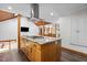 Kitchen island with cooktop and wood cabinets; open concept design with great natural light at 237 Jason Way, Youngsville, NC 27596
