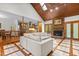 Cozy living room featuring a fireplace, wood ceiling, and an open view into the modern kitchen at 237 Jason Way, Youngsville, NC 27596