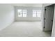 Spacious bedroom with plush carpeting and a pair of large windows at 2403 Whitewing Ln, Wendell, NC 27591