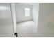 Bedroom with neutral carpet, a window providing natural light, and clean, white walls for a modern aesthetic at 2403 Whitewing Ln, Wendell, NC 27591