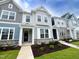 Beautiful townhome with stone accents, manicured lawn, and inviting covered entryway at 2403 Whitewing Ln, Wendell, NC 27591