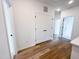 Hallway featuring hardwood floors and a double door closet at 2403 Whitewing Ln, Wendell, NC 27591