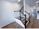 Elegant staircase with dark wood steps and white railings leading upstairs at 2403 Whitewing Ln, Wendell, NC 27591