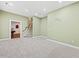 Carpeted basement area with staircase and doorway leading to another room at 244 Mantle Dr, Clayton, NC 27527