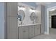 Bathroom with dual sinks, modern fixtures, gray cabinets and convenient access to closet at 244 Mantle Dr, Clayton, NC 27527