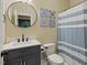 Modern bathroom with vanity and round mirror at 244 Mantle Dr, Clayton, NC 27527