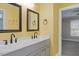 Bathroom with dual sink vanity, framed mirrors, modern lighting, and neutral color palette at 244 Mantle Dr, Clayton, NC 27527