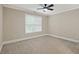 Cozy bedroom featuring a ceiling fan, natural light, and neutral carpet at 244 Mantle Dr, Clayton, NC 27527