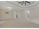 Large, carpeted bedroom with tray ceiling, recessed lighting, and easy access to bathroom at 244 Mantle Dr, Clayton, NC 27527