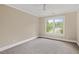 Bright bedroom with a large window overlooking a green, landscaped yard at 244 Mantle Dr, Clayton, NC 27527