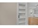 Built-in shelving detail connecting to a living area with shiplap and white cabinets at 244 Mantle Dr, Clayton, NC 27527