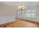Dining room with hardwood floors, crown molding, and a decorative chandelier at 244 Mantle Dr, Clayton, NC 27527