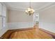 Dining room with hardwood floors, crown molding, and a decorative chandelier at 244 Mantle Dr, Clayton, NC 27527