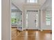 Bright foyer with hardwood floors, transom window above the front door, and natural light at 244 Mantle Dr, Clayton, NC 27527