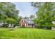 Charming brick two-story home featuring a well-manicured lawn, dormers, and a welcoming front porch at 244 Mantle Dr, Clayton, NC 27527