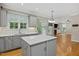 View of the kitchen featuring island, stainless steel appliances, and gray cabinetry at 244 Mantle Dr, Clayton, NC 27527