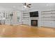 Open living room featuring built-in shelving and modern fireplace at 244 Mantle Dr, Clayton, NC 27527