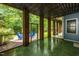 Enclosed porch with brick columns, opening to an outdoor patio area, providing a serene retreat at 244 Mantle Dr, Clayton, NC 27527