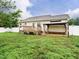 Backyard featuring a wooden deck, a patio with a gazebo, and a well-manicured lawn at 253 Middle Landing Dr, Smithfield, NC 27577