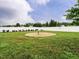 Spacious backyard featuring a round table surrounded by a well-maintained lawn and white fence at 253 Middle Landing Dr, Smithfield, NC 27577