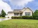 Charming single-story home featuring blue shutters and a well-manicured lawn at 253 Middle Landing Dr, Smithfield, NC 27577