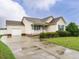 Quaint one-story home showcasing an attached garage and a freshly sealed driveway at 253 Middle Landing Dr, Smithfield, NC 27577