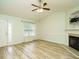 Inviting living room with new flooring, a ceiling fan and a cozy fireplace at 253 Middle Landing Dr, Smithfield, NC 27577
