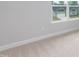 This bedroom features neutral carpet, natural light, and a view of the outdoors from the window at 263 Hopewell Branch Ct, Smithfield, NC 27577
