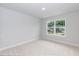 This bedroom offers natural light with neutral walls and carpeted flooring at 263 Hopewell Branch Ct, Smithfield, NC 27577