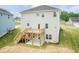 Exterior view of the house with a deck and a concrete patio area and yard at 263 Hopewell Branch Ct, Smithfield, NC 27577