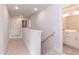 Hallway with carpet, handrail and access to bathroom with double sink vanity with white cabinets at 263 Hopewell Branch Ct, Smithfield, NC 27577