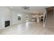 Bright living room with fireplace, ceiling fan, light wood flooring, and open access to the kitchen at 263 Hopewell Branch Ct, Smithfield, NC 27577
