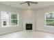 Bright living room featuring hardwood floors, a fireplace, and large windows at 263 Hopewell Branch Ct, Smithfield, NC 27577