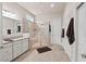 Bright bathroom featuring a glass shower, double sink vanity, and neutral tile flooring at 2633 Beckwith Rd, Apex, NC 27523