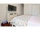Bedroom featuring wood floors, a dresser, and a large television screen mounted on the wall at 2633 Beckwith Rd, Apex, NC 27523