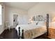 Cozy bedroom featuring hardwood floors, a black metal bed frame, and wooden nightstands at 2633 Beckwith Rd, Apex, NC 27523