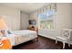 Cozy bedroom features hardwood floors, a mounted TV, and window with decorative valance at 2633 Beckwith Rd, Apex, NC 27523