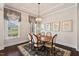 Elegant dining room showcasing a chandelier, a patterned rug, hardwood floors, and natural lighting at 2633 Beckwith Rd, Apex, NC 27523