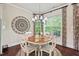 Bright dining room featuring hardwood floors and large windows with views of the outdoor space at 2633 Beckwith Rd, Apex, NC 27523