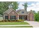 Charming, single-story home featuring a stone facade, manicured lawn, and inviting covered entrance at 2633 Beckwith Rd, Apex, NC 27523