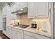 Modern kitchen with white cabinets, granite countertops, stainless steel appliances, and stylish backsplash at 2633 Beckwith Rd, Apex, NC 27523