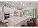 Stylish kitchen with a large island, granite countertops, stainless steel appliances, and ample cabinet space at 2633 Beckwith Rd, Apex, NC 27523